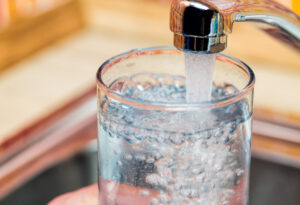 A glass being filled with drinking water from a faucet in El Paso.